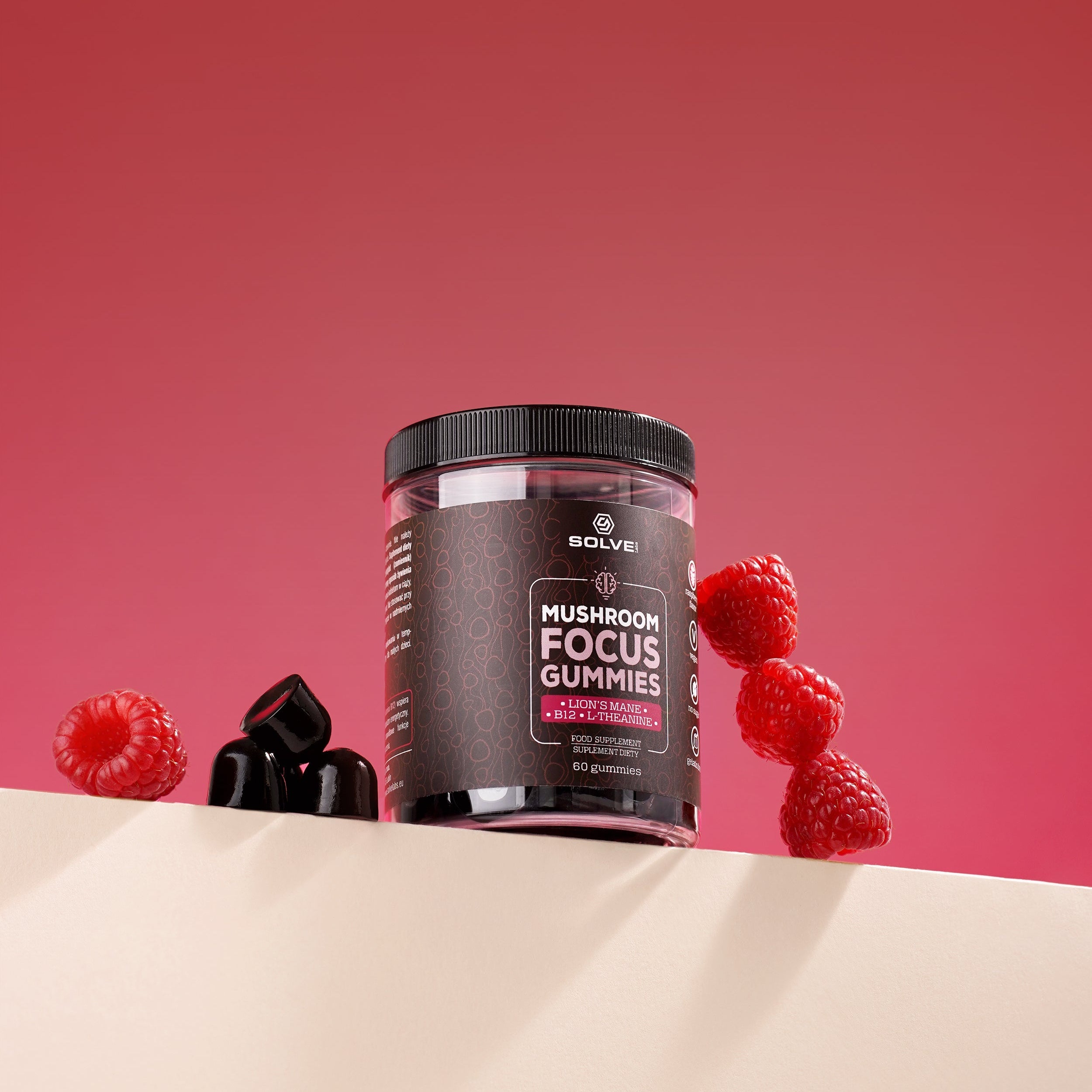 Mushroom focus gummies container with raspberries and dark chocolates on a pink background