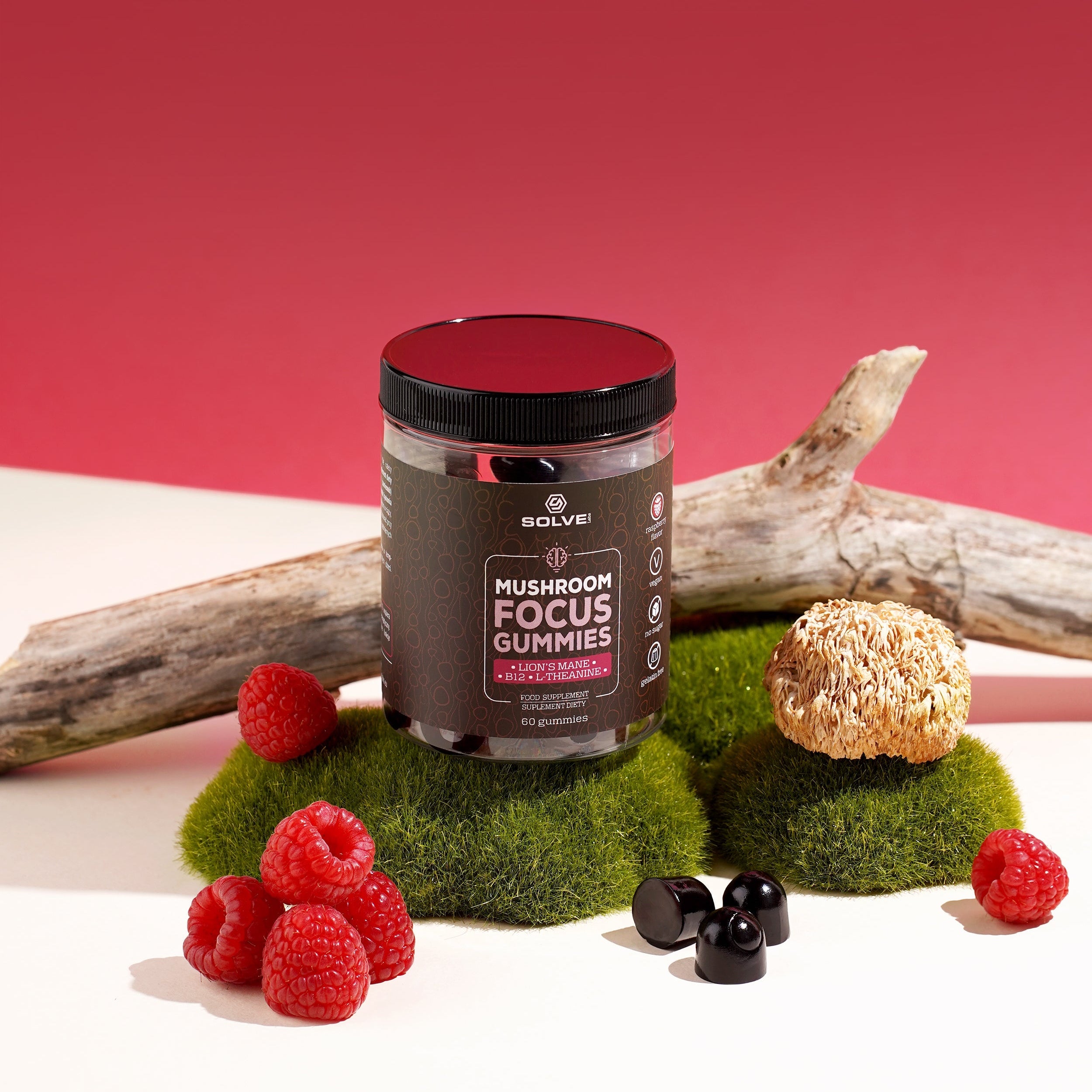 Jar of 'Mushroom Focus Gummies' with berries and a branch on a red background